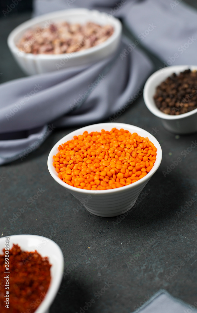 Sumakh and red lentils in a white bowl on a wooden board Sumakh and red lentils in a white bowl on a wooden board