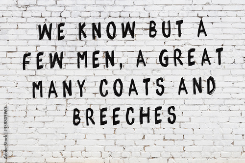 White brick wall with painted black inscription of wise quote
