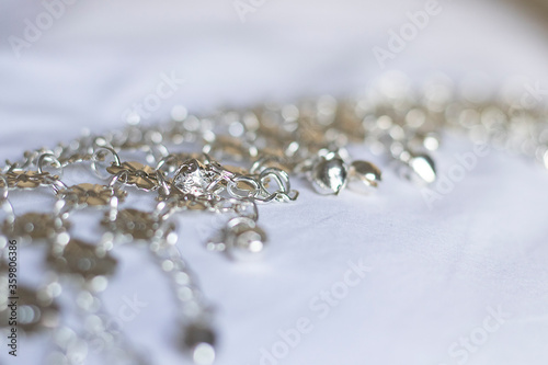 silver jewelry charms on a white fabric