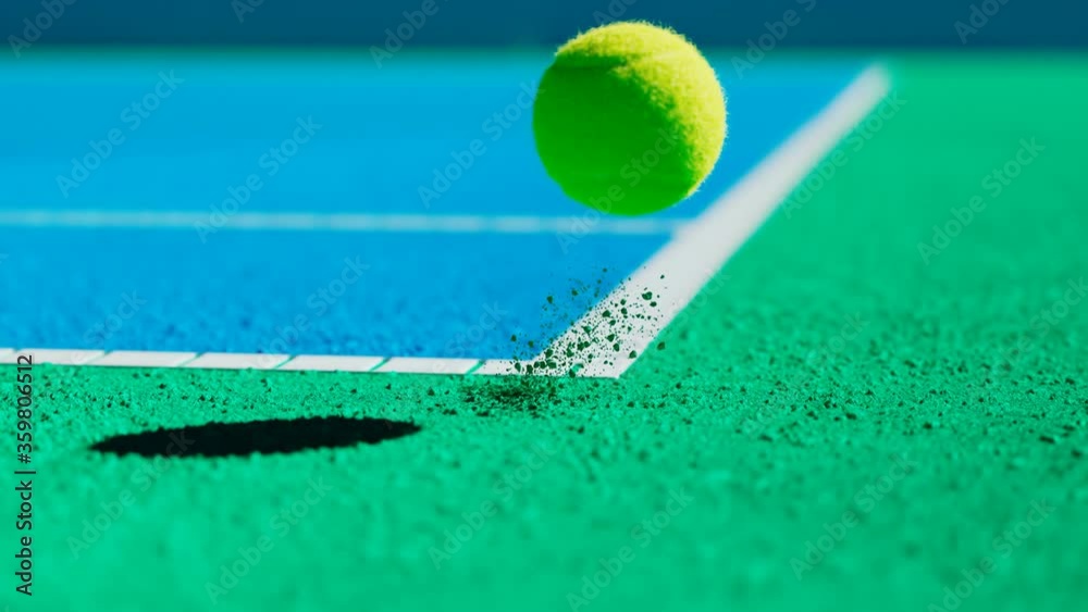 Slow-motion animation of a tennis ball hitting outside the court.The ball is out