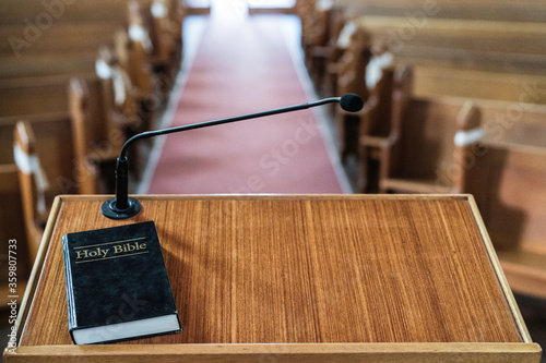 Bible on church pulpit in empty church photo