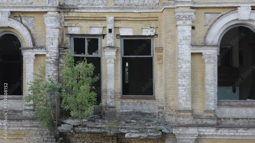 Broken windows in abandoned old manor (mansion) house. Deserted 19th century building. Aerial side view. Broken windows in abandoned old manor (mansion) house. Deserted 19th century building. Aerial side view.