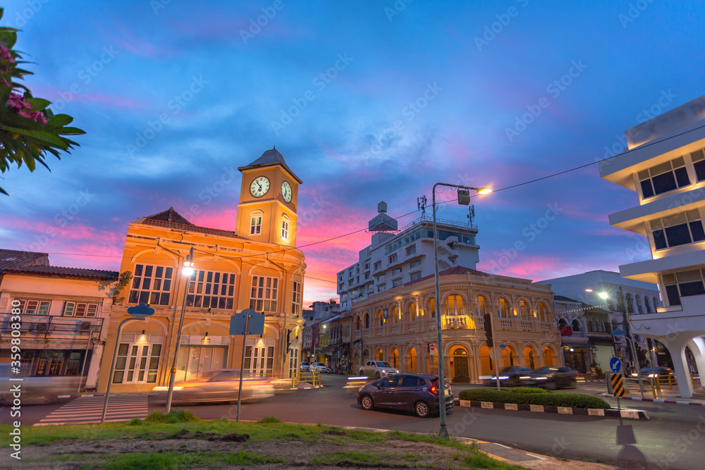 sunset behind the old architectural style in Phuket city.the clock tower was built in Chino portuguese style..