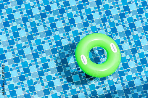 Green rubber ring in swimming pool 