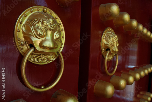 The ancient gate of the temple. Handles of the temple in the form of lions. © stocknik