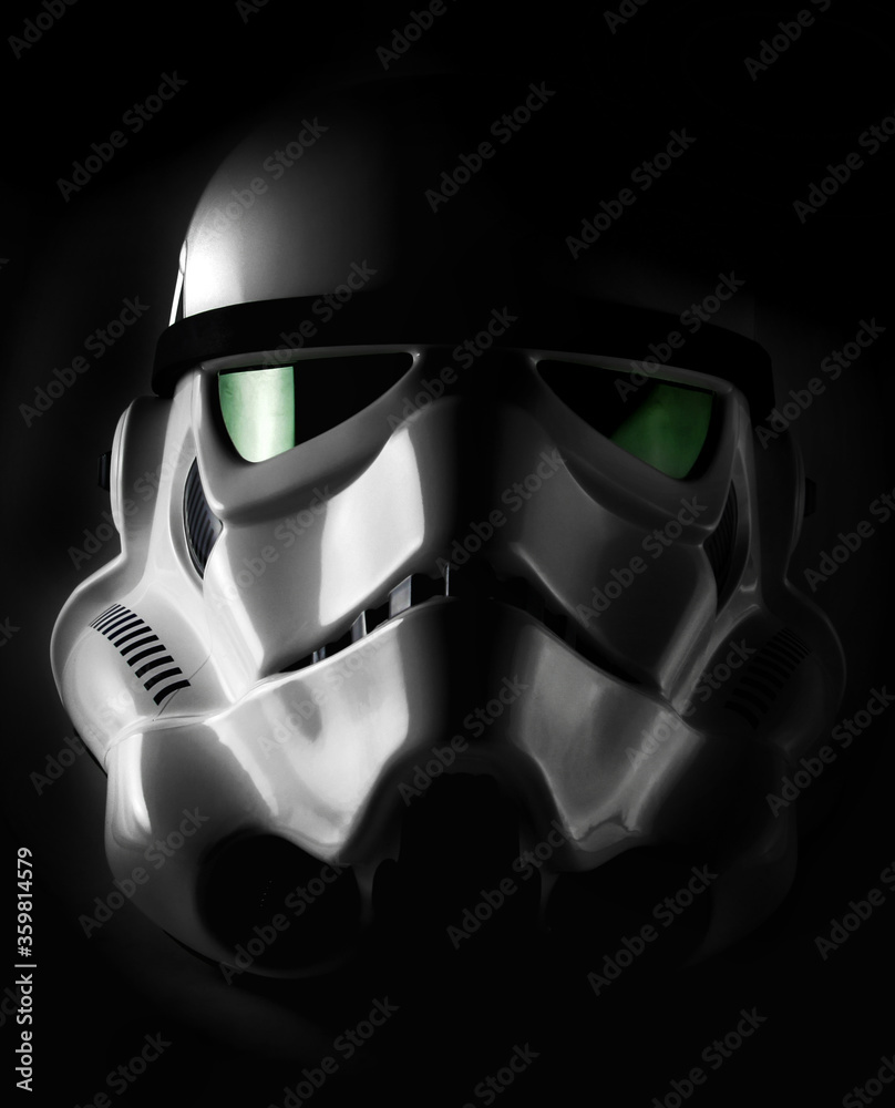 Fototapeta premium NEW YORK, USA - NOV 7 2015: Studio portrait of an EFX brand Star Wars ANH Stormtrooper helmet with dramatic lighting. The Star Wars franchise is owned by Disney