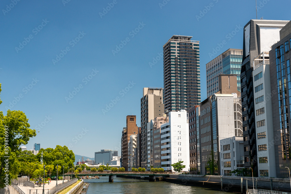 View of office buildings along Tosabori river, shot from Yodoyabashi bridge in Osaka, Japan