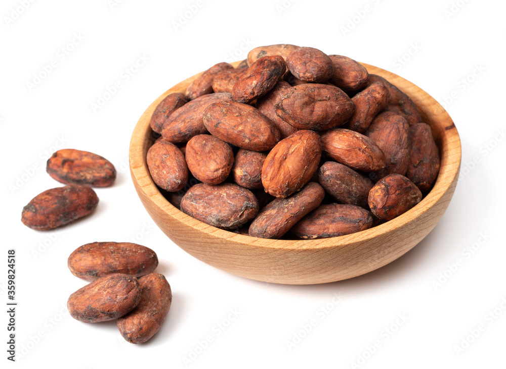 unpeeled cocoa beans in the wooden bowl, isolated on white background unpeeled cocoa beans in the wooden bowl, isolated on white background