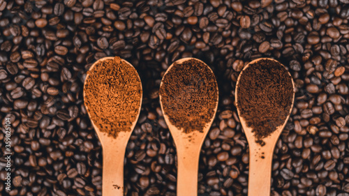 Ground coffee in a spoon on the background