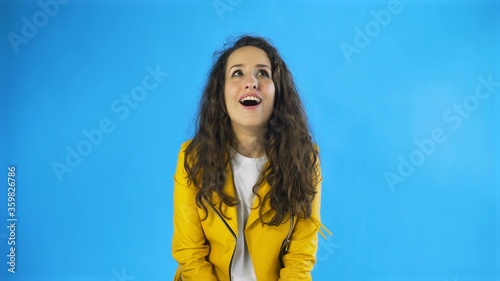 Portrait of pretty brunette long-haired woman WOW gesture