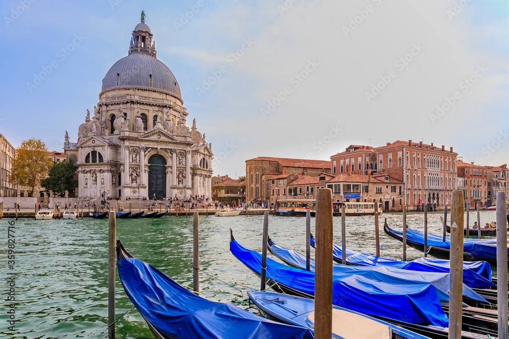 Gondolas along the Grand Canal across from the iconic 17th-century Santa Maria di Salute Basilica in Venice Italy