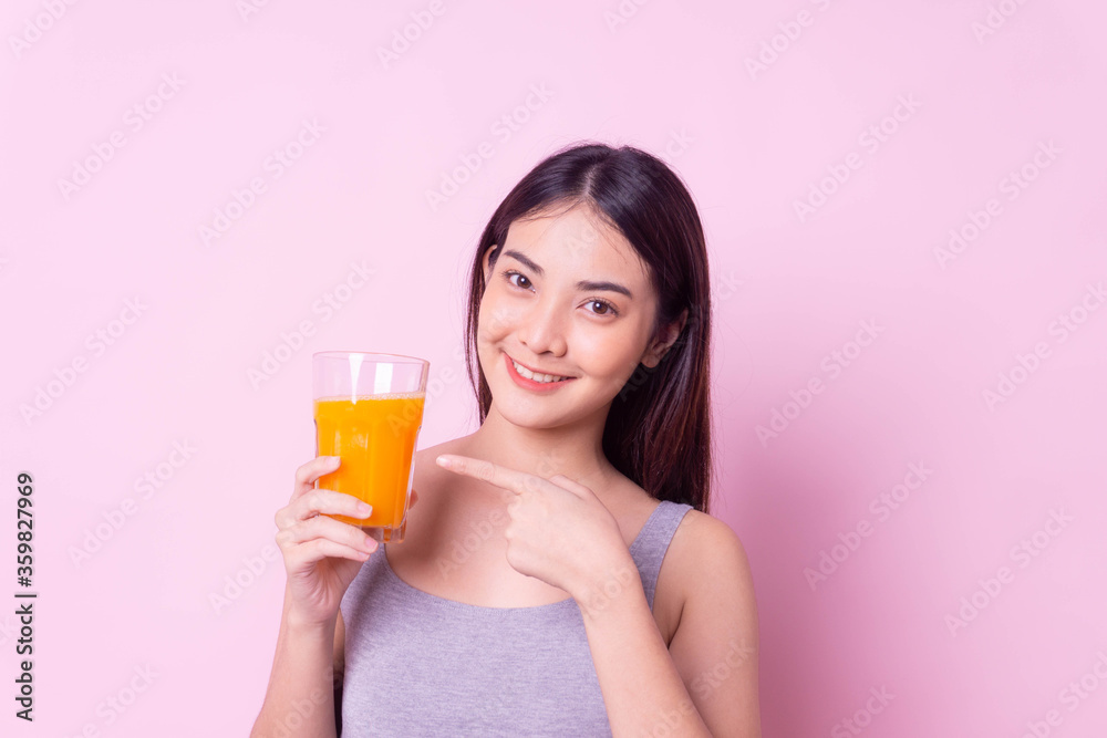 Healthy woman diet drinking orange juice for health, sport portrait asian girl isolated pink background,healthy drink and clean food concept,copy space Healthy woman diet drinking orange juice for health, sport portrait asian girl isolated pink background,healthy drink and clean food concept,copy space