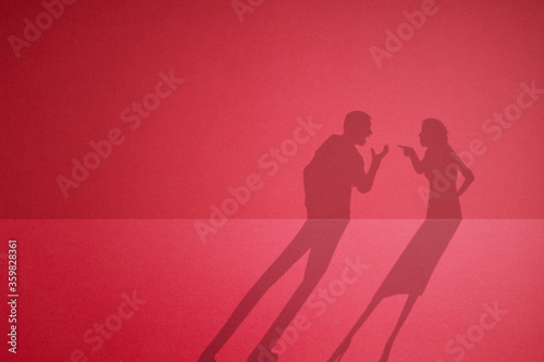 The shadow of a quarreling couple. fight between husband and wife.