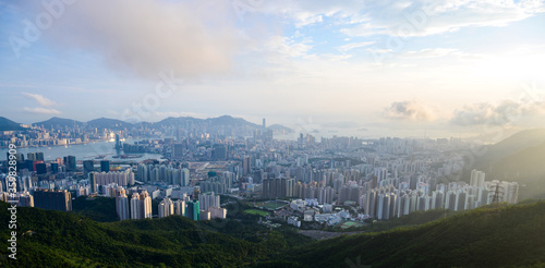 Aerial scenery panoramic view of Hong Kong from hight mountains with metropolitan bay Victoria Harbor modern cityscape, urban skyline buildings © chokniti
