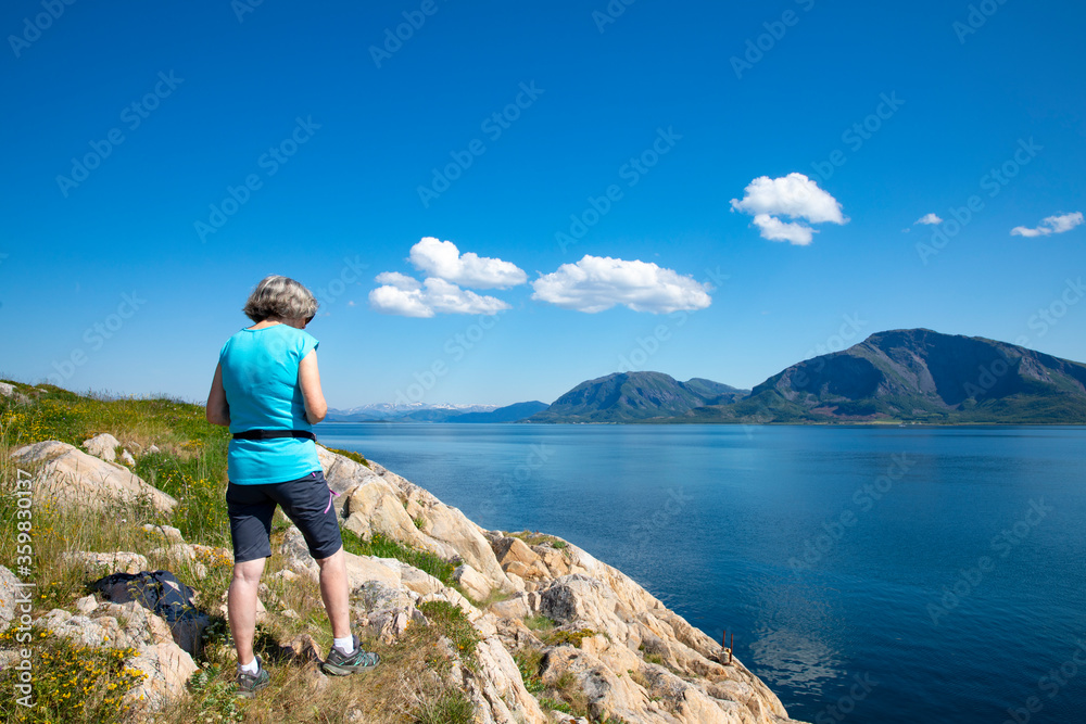 Woman hike to Vikerheia a great summer day in Nordland county