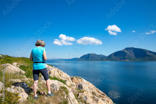 Woman hike to Vikerheia a great summer day in Nordland county