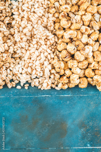 Popcorn and kettle corns on a blue background photo