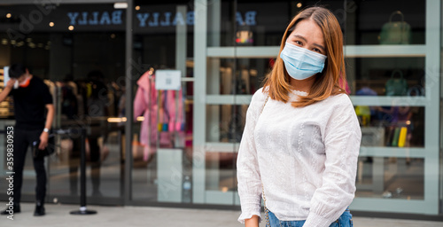 young woman with shopping bags and  protect face mask. Women with face mask travel in the city new life in the city © Hide_Studio