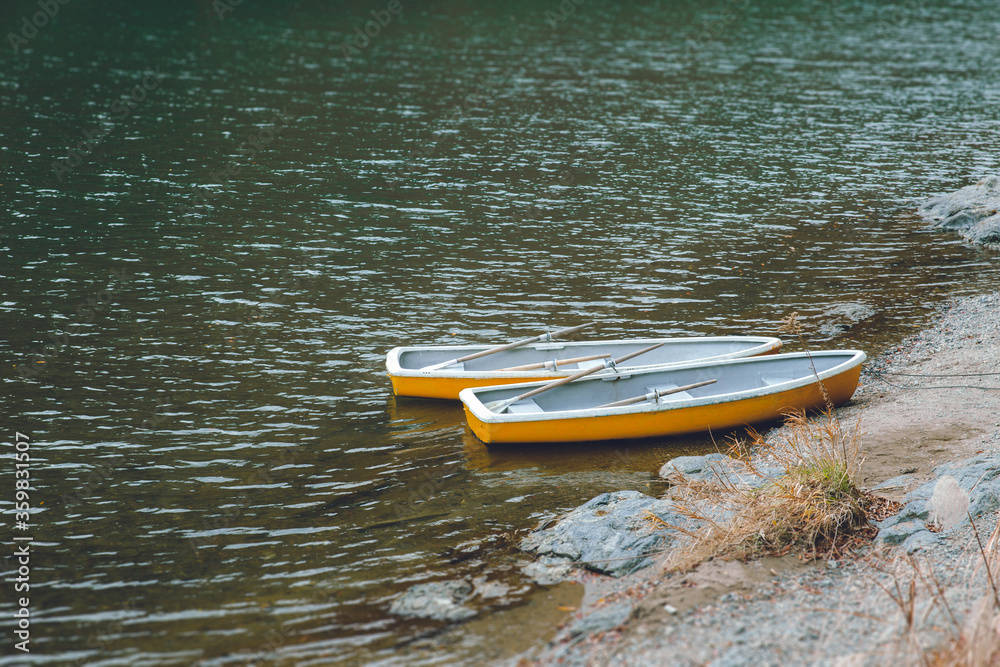 Two wooden boat with no people in quiet lake, no traveller and tourist impact of Coronavirus(COVID-19) outbreak Two wooden boat with no people in quiet lake, no traveller and tourist impact of Coronavirus(COVID-19) outbreak