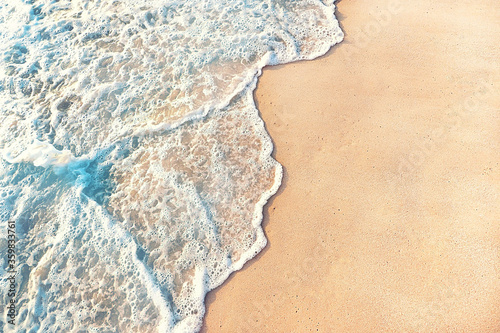 clear water wave coming to the clean beach sand