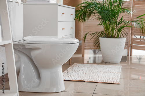 Modern toilet bowl in interior of restroom