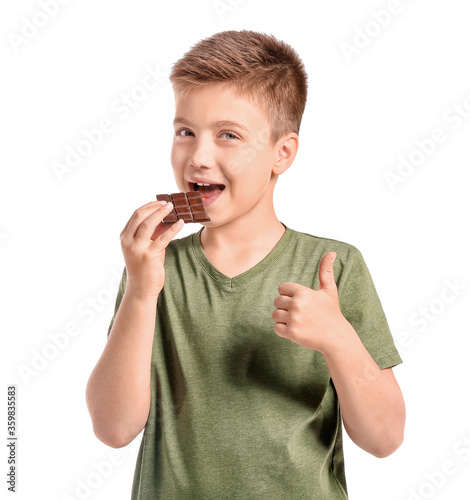 Cute little boy eating choc...
