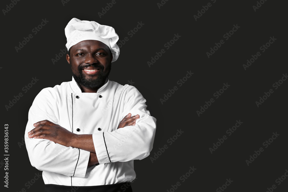 Male African-American chef on dark background Male African-American chef on dark background