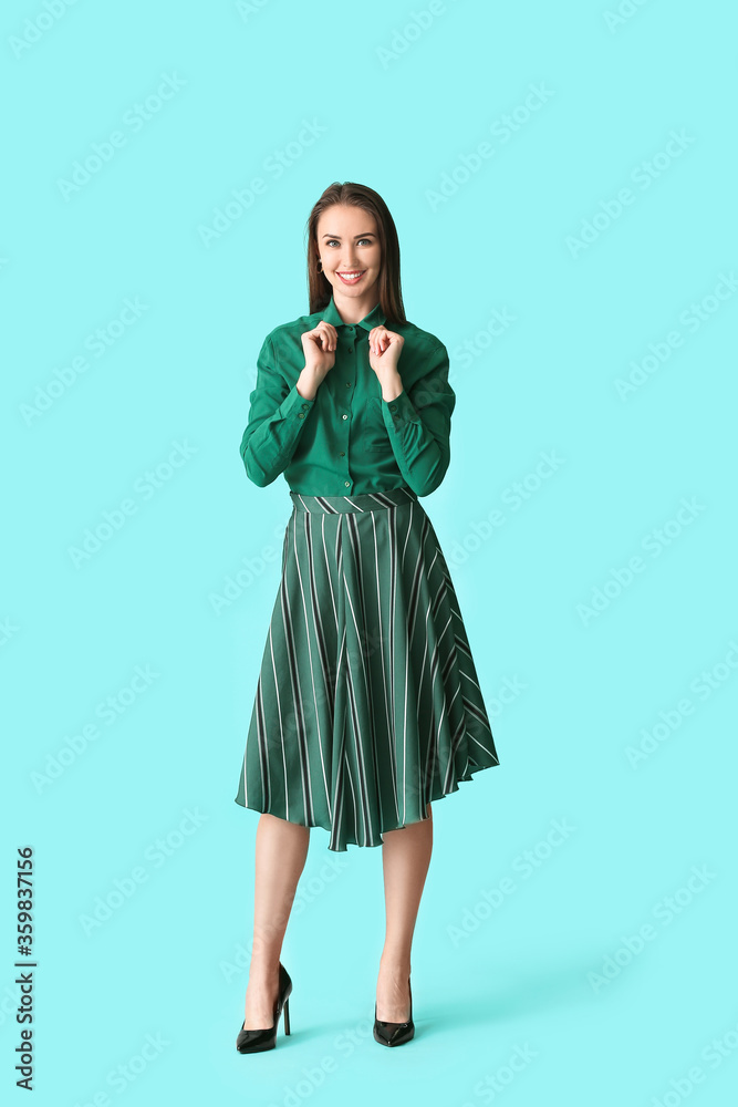 Beautiful young businesswoman in stylish shirt on color background Beautiful young businesswoman in stylish shirt on color background
