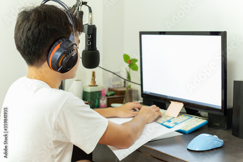 Asian teenage boy study at home uses pc online class during Quarantine covid-19.