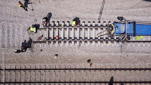 Railroad workers repairing a broken track. Repairing railway. Rail tracks maintenance process.