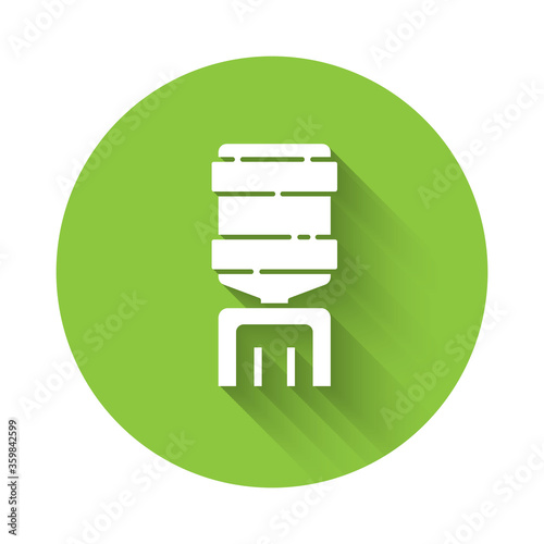 White Water cooler for office and home icon isolated with long shadow. Water dispenser. Bottle office, plastic and liquid. Green circle button. Vector Illustration.