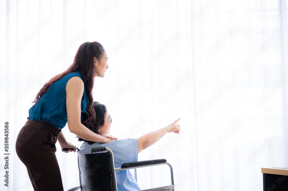The home nursing volunteer take care of the elderly old age patient on the wheel chair after doctor examination at hospital. The home nursing volunteer take care of the elderly old age patient on the wheel chair after doctor examination at hospital.