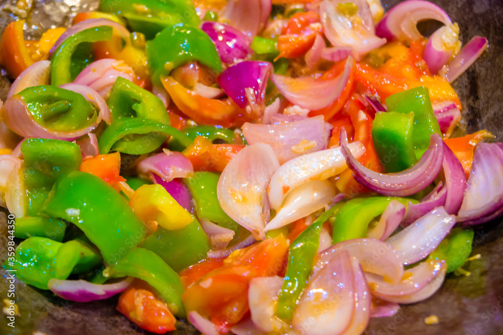 Stir fried colorful vegetables in a wok, Healthy food. Concept for a tasty and healthy vegetarian meal. Close up
Stir fried colorful vegetables in a wok, Healthy food. Concept for a tasty and healthy vegetarian meal. Close up