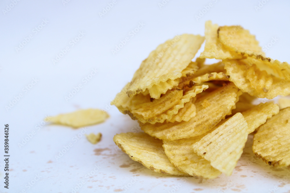 crunchy potato chips on white background
