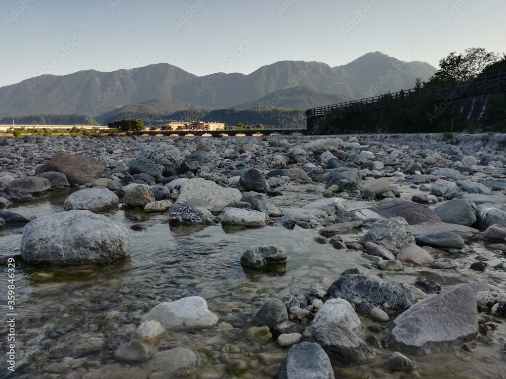 Beautiful view of river rocks with mountains in the background.