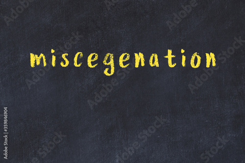 College chalk desk with the word miscegenation written on in photo