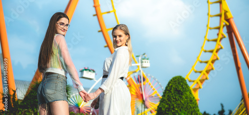 LGBT concept, couple of gay woman enjoying and happy at an amusement theme park