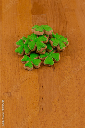 clover symbol St. Patrick's Day folded in a pile on the hands of a woman close-up toned background