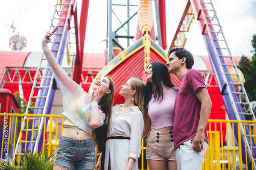 group of friends having fun and relaxing at an amusement theme park, happy time with young team