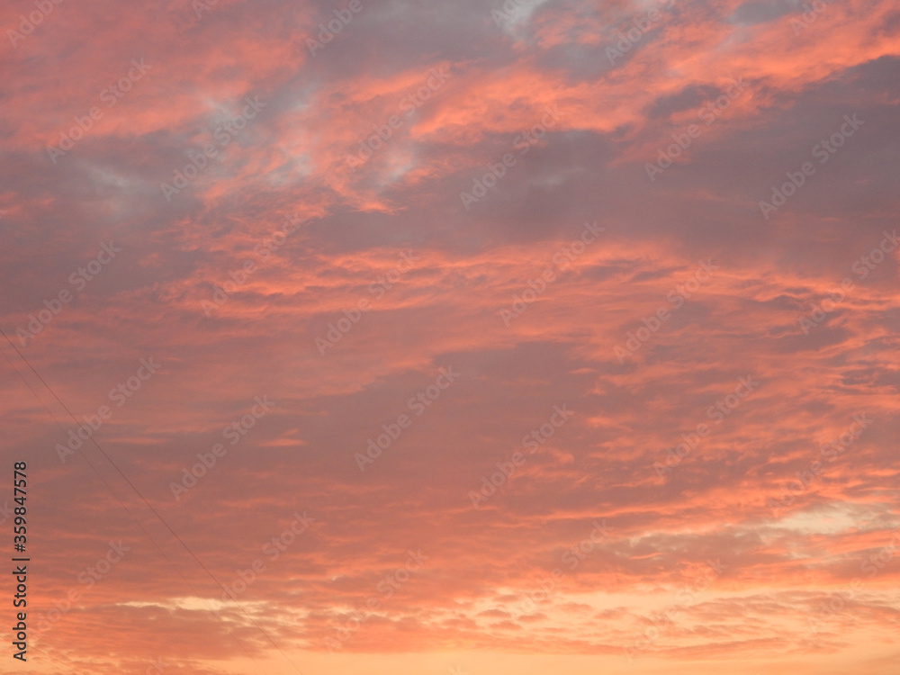 sunset sky with clouds in red yellow purple colors