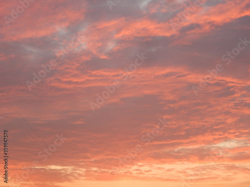 sunset sky with clouds in red yellow purple colors © Natalia