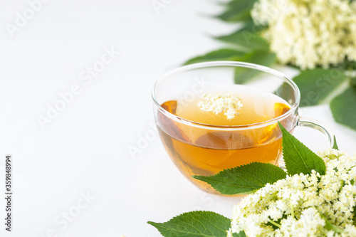 Tea and syrup from elderberry flowers Sambucus nigra on a white background. Copy space