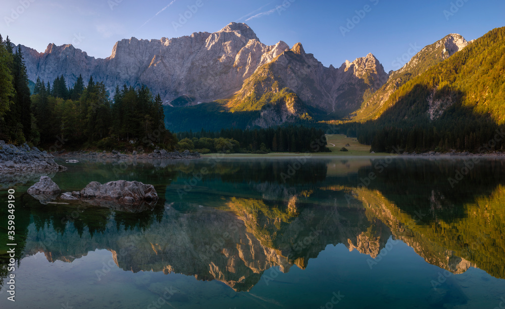 Panorama of an alpine lake on a beautiful sunny morning