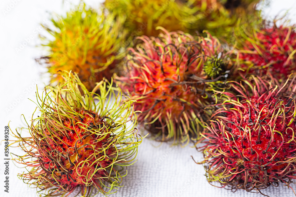 whole tropical rambutan red fruit on white background close-up whole tropical rambutan red fruit on white background close-up