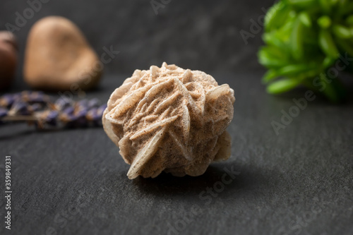 фотографія A closeup view of a desert rose selenite rock crystal, in a still life setting