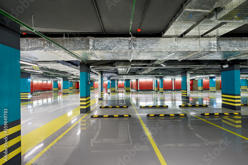Large modern underground parking for cars. Empty, new not used underground car parking, garage