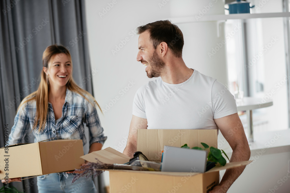 Husband and wife are moving in a apartment. Husband and wife are unpacking their belongins. Husband and wife are moving in a apartment. Husband and wife are unpacking their belongins.