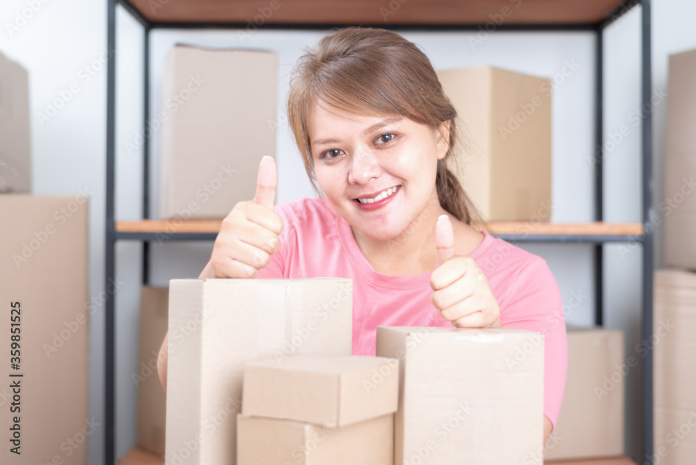 Selling online work from home. Women business owner working at home with packing box on the workplace - online shopping Selling online work from home. Women business owner working at home with packing box on the workplace - online shopping
