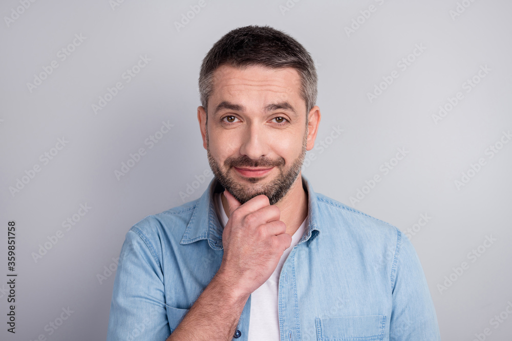 Close-up portrait of his he nice attractive content cheery guy worker touching chin overthinking solution decision solving isolated over gray light pastel color background Close-up portrait of his he nice attractive content cheery guy worker touching chin overthinking solution decision solving isolated over gray light pastel color background