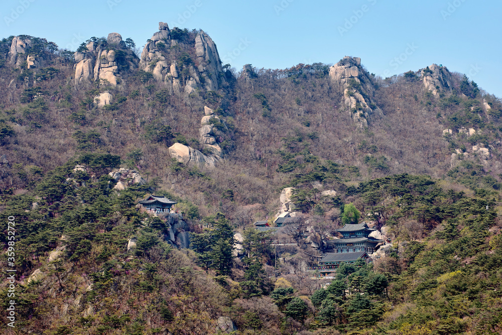 View of a temple on steep and lush hillside at the Bukhansan National Park in Seoul, South Korea. View of a temple on steep and lush hillside at the Bukhansan National Park in Seoul, South Korea.